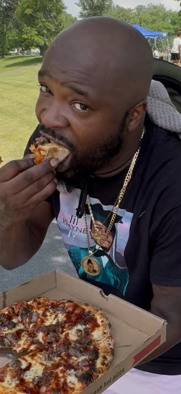 Customer eating pizza at outdoor event