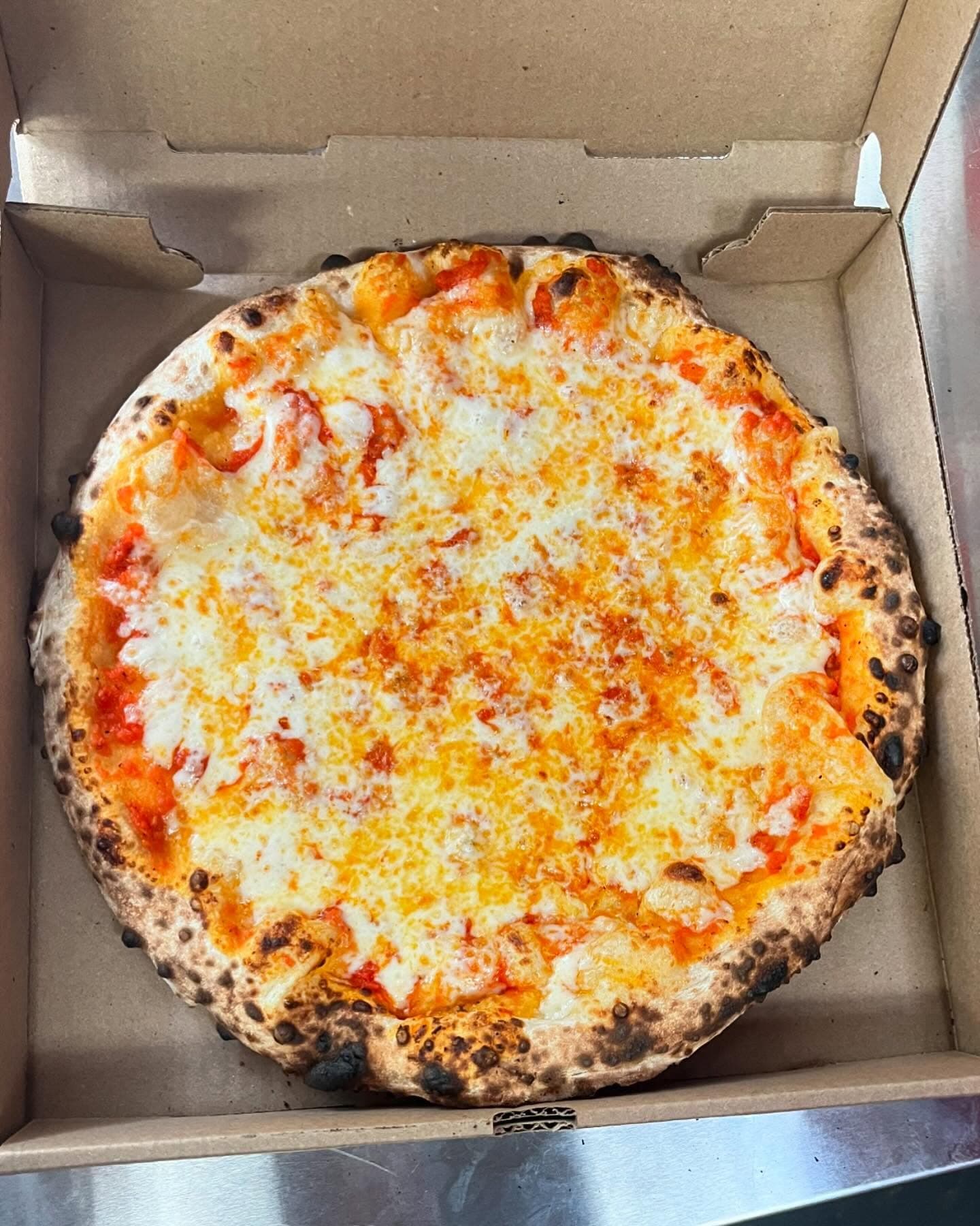 Cheese pizza in box overhead